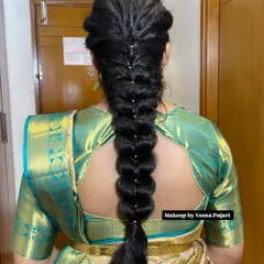 A beautiful and intricate fishtail braid, adorned with small pearls. This hairstyle is a modern twist on a traditional look.