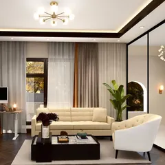 This space was designed for modern, multifunctional living. A comfortable living area, featuring our custom sofa and armchair, coexists with a discreet home office nook, unified by a consistent palette of warm neutrals and dark wood accents.