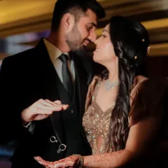 A close-up shot capturing the intimacy and romance of an engagement, focusing on the couple's connection and the beautiful henna on the bride's hands.