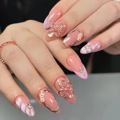 Pink perfection with a touch of 3D magic. This stunning set features a glossy pink base with sculpted gold-framed flowers, sparkling starbursts, and a dreamy marble effect on the accent nails.