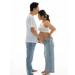Simple, timeless, and full of love. A classic couple's maternity portrait in our Delhi studio, showing that sometimes all you need is a white tee, your favorite jeans, and each other.