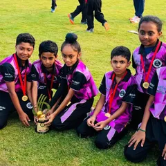 Young players from our U-10 team with their medals and trophy, celebrating their achievement with smiles.