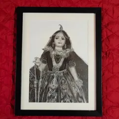 My Radha Rani portrait, framed and ready to be placed in a sacred space. The simple black frame with a white border helps to draw the eye to the intricate details of the graphite sketch.