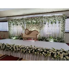 Another view of the white floral stage setup.