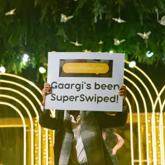 A prop sign showing a "SuperSwiped" notification, creatively telling the story of how the couple met online.
