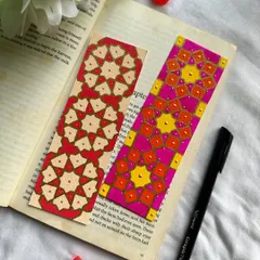 These bookmarks are inspired by Islamic geometric patterns. The one on the right features a bright pink and orange design, while the one on the left uses a more subdued red and cream palette.