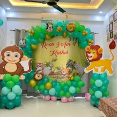 For kids' birthdays, I create fun, themed decorations like this jungle-inspired setup for a 4th birthday. It includes a full balloon arch in shades of green, a personalized backdrop, and large cutouts of favorite animal characters like a monkey and lion, making it a great photo spot.