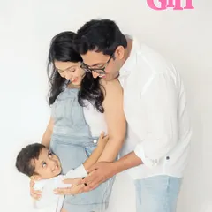 A fun and loving family moment announcing their baby girl. The older brother-to-be gives his mom's bump a big hug, full of excitement for his new sibling.