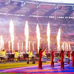 The power of a live performance is in the details. Here, a synchronized drum line is amplified by perfectly timed pyrotechnics during the ICC Men's T20 World Cup opening ceremony, creating a high-energy spectacle.