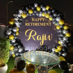 I designed this personalized retirement party decoration for an outdoor event. It features a custom backdrop with the retiree's name and a sophisticated black, gold, and silver balloon arch, perfect for corporate farewells.