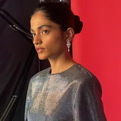 Another portrait from the same BTS series, capturing the model's profile and the elegant silver dress.