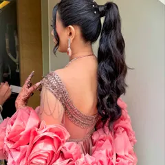 A glamorous high ponytail with soft, voluminous waves, accented with delicate pearls at the base. This chic and modern hairstyle is a fantastic choice for a Sangeet or Cocktail party, offering both style and comfort for a night of dancing.