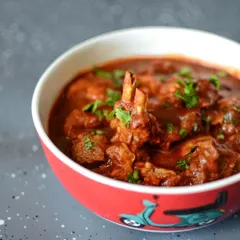 A close-up of our signature Kashmiri Rogan Josh. We slow-cook tender mutton in a rich, aromatic gravy with authentic spices. This dish is a testament to our passion for gourmet North Indian cuisine, delivering deep flavor without being overly spicy.