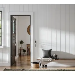 A simple yet elegant entryway featuring vertical shiplap wall paneling. This detail adds texture and character to the space, creating a warm and welcoming first impression.