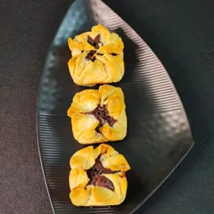 My innovative Baklava Brownie Bites. These unique treats feature a rich brownie filling wrapped in flaky, golden-brown phyllo pastry, offering a delightful fusion of two classic desserts.