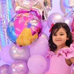 The birthday girl posing with her favorite princess balloons. We make sure to capture the little details and themes that make your child's party special.