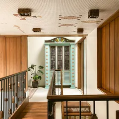 This custom bar cabinet was designed as a centerpiece for a landing. Inspired by Chettinad architecture, it features stained glass panels and a playful colour palette of mint green and ochre, making it a joyful and nostalgic statement piece.
