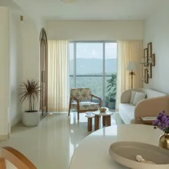 This living space embodies whitewashed serenity, designed as a peaceful retreat with stunning natural views. We used a soft, neutral palette and minimalist furniture to create an atmosphere of calm. The design prioritizes natural light, making the room feel airy and expansive.