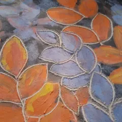 A close up of the texture created by sgraffito. You can see how the carved lines add depth and detail to the painted leaves.