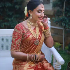 A candid moment of joy. This look showcases a flawless base, defined eyes, and a bright smile, capturing the essence of a happy South Indian bride on her wedding day.