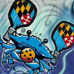 A close-up of the pickleball crab character, holding paddles. I love creating fun, custom characters for my graffiti work.