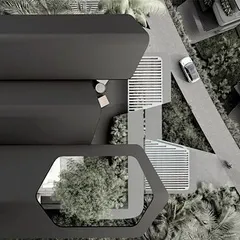 An aerial view of the Dona Paula homes, showcasing the unique hexagonal cutouts in the roof structures. These openings allow for rooftop gardens and light wells, bringing nature directly into the home and breaking down the mass of the building.