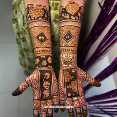 A full view of a special baby shower mehendi, incorporating baby feet, a cradle, and a portrait of Balakrishna, celebrating the new life to come.