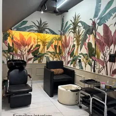 For the shampoo and pedicure section, we used a vibrant, tropical wallpaper and lower wall moulding to create a distinct, relaxing zone. Even in a small corner, we designed a space that feels like a mini-getaway for clients.