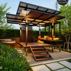 This elevated garden lounge is a stunning example of a modern retreat. The pergola features a two-tiered roof and is set on a wooden deck, creating a luxurious, resort-style feel with vibrant cushions for a pop of color.