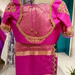 A closer look at the craftsmanship. The back features a deep cut with elegant ties and tassels.
