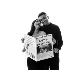 Extra, extra, read all about it! I love this creative newspaper prop that announces "Baby is on the Way." It's a unique and memorable idea for a pregnancy announcement, captured here in a timeless black and white photo.
