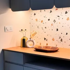 This little corner is designed to feel calm and grounded. A terrazzo backsplash is paired with a wooden countertop and minimalist blue-grey cabinets, creating a quiet elegance with soft, under-cabinet lighting.