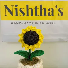My little sunflower pot sitting proudly in front of our brand packaging. Each piece is handmade with hope and sent out to bring a smile to your face.