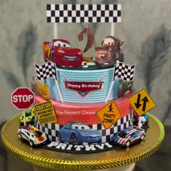 One of my most popular designs for kids' birthdays. This two-tier Lightning McQueen cake brings the race track to the party, complete with all the favorite characters. This one was made with my special Royal Rasmalai flavour.