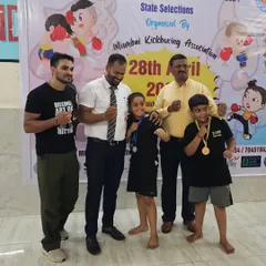 Proud coaches with our young medal winners at the Mumbai Kickboxing Championship. We guide them every step of the way, from training in the gym to celebrating their victories.