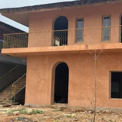 The finished look of an exterior wall with an earthy, terracotta-colored lime plaster texture. This finish is not only beautiful but also highly durable and suitable for the Indian climate.