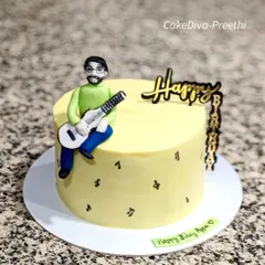 A simple yet personal cake for a guitarist. It features a custom fondant figurine of the birthday person with his guitar, sitting atop a delicious pineapple ganache cake.