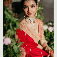Our radiant bride, framed by a lush floral backdrop. We work to ensure the decor complements the couple, making their moments in the mandap even more magical and picture-perfect.