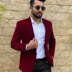 A bold red velvet blazer paired with a crisp white shirt is a statement look for any reception or cocktail party. It's all about confidence and style.