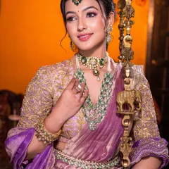For this South Indian bridal look, we paired a modern lilac saree with traditional emerald jewelry. I focused on creating dewy, luminous skin and soft, defined eyes to achieve a look that felt both royal and effortlessly graceful.