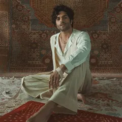 The full look of the layered white ensemble, showcasing its relaxed yet sophisticated silhouette. This is bespoke artistry that tells a story.