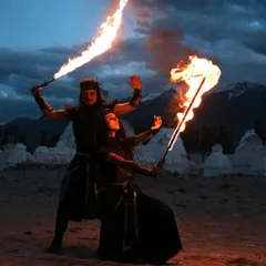 A duo performance set against a dramatic twilight landscape. We use fire swords to paint the air with light, creating a choreographed story of conflict and harmony. This is an example of our site-specific, epic storytelling shows.