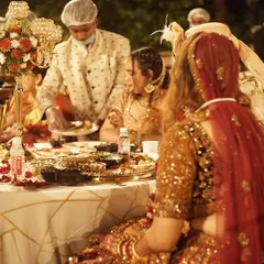 A beautiful moment captured at a wedding dinner I catered. The couple is enjoying their meal as my staff serves them at their table, ensuring a special experience.