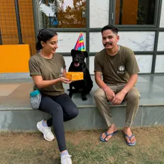 Celebrating our resident wiggle-bum queen, Laika, on her birthday. She's posing with her cake alongside me and one of our dedicated team members.