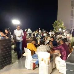 Guests enjoying an outdoor dinner party at a private residence. Our team handles all aspects of catering for house parties, allowing you to be a guest at your own event.