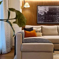 This peek into the media room shows the warm and cozy ambiance I created. The wood-paneled accent wall, soft backlighting, and comfortable sofa make it the perfect setup for family movie time or even a quiet meditation session.