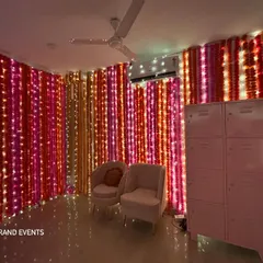 This photo shows a beautiful photo corner created with walls of marigold and tuberose flower strings. The addition of fairy lights makes the colors pop, perfect for festive pictures.