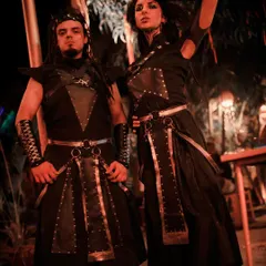 A full view of our warrior duo's costumes, featuring leather, studs, and custom armor pieces. This theme is perfect for medieval fairs, fantasy conventions, and themed parties.