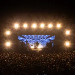 Capturing the full scale of a live event, this shot shows the entire stage setup for Amit Mishra's concert, with dramatic lighting and the energy of the audience.