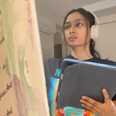 The art I create is how I'm feeling or dreaming. It’s my way of channeling emotions and taking care of my heart. This is a quiet, reflective moment during my painting process, where I'm just listening to what the canvas needs.
